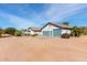 Charming house with blue garage doors, desert landscaping, and bright natural light at 6404 S Lazy Ln, Gold Canyon, AZ 85118