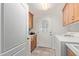 Functional laundry room with washer, dryer, storage and access to the backyard through the door at 6404 S Lazy Ln, Gold Canyon, AZ 85118