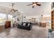 Open-concept living room featuring tile floors, ceiling fans, and an adjacent dining area and kitchen at 6404 S Lazy Ln, Gold Canyon, AZ 85118