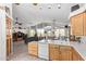 Open-concept living space with kitchen, dining area, and living room with large windows at 6404 S Lazy Ln, Gold Canyon, AZ 85118