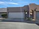 Charming Southwestern-style home featuring a two-car garage and arched entryway to a private courtyard at 6411 S River Dr # 53, Tempe, AZ 85283