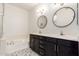 Bathroom featuring a double sink vanity, patterned tile floors, and a bathtub at 6605 N 93Rd Ave # 1022, Glendale, AZ 85305