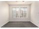 Neutral carpeted bedroom with white walls, two large windows, and a ceiling fan at 6605 N 93Rd Ave # 1022, Glendale, AZ 85305