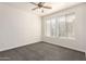 Bright bedroom with neutral carpet, two windows with blinds, and a ceiling fan at 6605 N 93Rd Ave # 1022, Glendale, AZ 85305