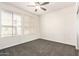Bedroom with neutral carpet, two large windows, a ceiling fan, and closet with mirrored doors at 6605 N 93Rd Ave # 1022, Glendale, AZ 85305