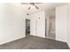 Spacious bedroom with neutral carpet, ceiling fan, and doorways to the bathroom and hallway at 6605 N 93Rd Ave # 1022, Glendale, AZ 85305