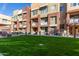 Townhome exterior displays grassy communal areas, colorful facades, awnings, and seating at 6605 N 93Rd Ave # 1022, Glendale, AZ 85305