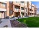 Lush green grass and colorful townhome facades with awning accents define the community's exterior at 6605 N 93Rd Ave # 1022, Glendale, AZ 85305