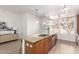 Kitchen island with bar seating, stainless steel appliances, and light wood cabinets, with bright natural light at 6605 N 93Rd Ave # 1022, Glendale, AZ 85305