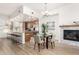 Bright, open kitchen with a large island, stainless steel appliances, and cozy dining area with fireplace at 6605 N 93Rd Ave # 1022, Glendale, AZ 85305