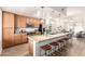 Open kitchen layout with island, stainless steel appliances, light wood cabinets, and easy access to living areas at 6605 N 93Rd Ave # 1022, Glendale, AZ 85305
