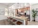 Bright kitchen with granite island, stainless steel appliances, barstool seating and light wood cabinets at 6605 N 93Rd Ave # 1022, Glendale, AZ 85305