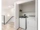 Laundry room with white washer and dryer, storage shelves, and patterned tile floors at 6605 N 93Rd Ave # 1022, Glendale, AZ 85305