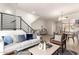 Open concept living room featuring modern furnishings, sleek metal staircase, and light wood floors at 6605 N 93Rd Ave # 1022, Glendale, AZ 85305