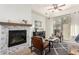 Sun-lit living room has a marble fireplace, modern furnishings, and a sliding glass door at 6605 N 93Rd Ave # 1022, Glendale, AZ 85305