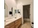 Bathroom with double sink vanity, mirrors, and tile floors at 757 W Magma Rd, San Tan Valley, AZ 85143