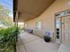 Covered front patio featuring a comfortable bench and security system near the entrance at 757 W Magma Rd, San Tan Valley, AZ 85143
