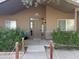 Inviting front entrance with a well-maintained walkway, mature bushes, and security system at 757 W Magma Rd, San Tan Valley, AZ 85143