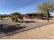 Expansive front yard with desert landscaping, seating, and a covered patio invites relaxation at 757 W Magma Rd, San Tan Valley, AZ 85143