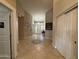 Hallway with tiled floors, closet doors, and a view of the front entrance at 757 W Magma Rd, San Tan Valley, AZ 85143