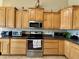 Well-lit kitchen with appliances, wooden cabinets, and ample counter space at 757 W Magma Rd, San Tan Valley, AZ 85143