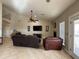 Spacious living room with vaulted ceilings, ceiling fan, fireplace, and tile floors at 757 W Magma Rd, San Tan Valley, AZ 85143