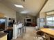 Open-concept living room with tiled floors, large windows and skylight for natural light at 757 W Magma Rd, San Tan Valley, AZ 85143