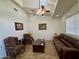Relaxing sitting room with a sofa, armchairs, ceiling fan, and natural light at 757 W Magma Rd, San Tan Valley, AZ 85143