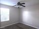 Bedroom with a ceiling fan, carpet flooring, and natural light from a window at 7903 E Harmony Ave, Mesa, AZ 85209