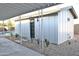 Exterior side view of building with desert landscaping, covered patio, and a partial view of the pool at 802 E Campus Dr, Tempe, AZ 85282