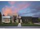 Contemporary home showcasing a striking facade, manicured lawn, and modern design elements at dusk at 86Xx E Stagecoach Pass # 4, Carefree, AZ 85377