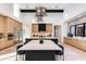Open-concept kitchen with a large island, stainless steel appliances, and stylish pendant lighting at 86Xx E Stagecoach Pass # 4, Carefree, AZ 85377