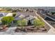 Expansive aerial view of the single-Gathering home featuring a red tile roof, desert landscaping, and block wall enclosed backyard at 9183 W Foothill Dr, Peoria, AZ 85383