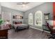 Well-lit bedroom includes hardwood floors, a ceiling fan, and two sunny windows at 9183 W Foothill Dr, Peoria, AZ 85383