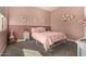 Pink bedroom with a twin bed with decorations hanging on the wall at 9183 W Foothill Dr, Peoria, AZ 85383