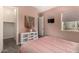A stylish bedroom with a light pink paint, features a cute wall decor and carpeted floors at 9183 W Foothill Dr, Peoria, AZ 85383