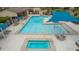 Spacious community pool area with shaded seating, offering a refreshing and relaxing amenity for residents of all ages at 9183 W Foothill Dr, Peoria, AZ 85383