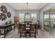 Elegant dining room with stylish seating, modern decor, and access to outdoor patio at 9183 W Foothill Dr, Peoria, AZ 85383