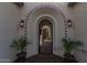 Inviting front entryway with decorative archway, potted plants, and a glimpse into the home's stylish interior at 9183 W Foothill Dr, Peoria, AZ 85383