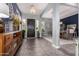Grand foyer with tiled flooring, elegant chandelier, stylish console table, and a view of the formal dining area at 9183 W Foothill Dr, Peoria, AZ 85383