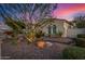Beautifully landscaped front yard with desert plants and a charming home facade in a serene desert setting at twilight at 9183 W Foothill Dr, Peoria, AZ 85383