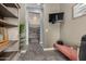 Hallway with tile floors, bench, built-in shelves, and a view of a large walk-in closet at 9183 W Foothill Dr, Peoria, AZ 85383