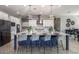 Kitchen island features seating, stylish lighting, and a stone countertop, ideal for entertaining at 9183 W Foothill Dr, Peoria, AZ 85383