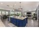 Open-concept kitchen boasts a large island with stainless steel appliances and modern pendant lighting at 9183 W Foothill Dr, Peoria, AZ 85383