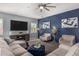 Comfortable living room features an accent wall, large TV, and plush seating at 9183 W Foothill Dr, Peoria, AZ 85383