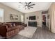 Comfortable living room showcases a big screen tv, wood floors, and large sectional couch at 9183 W Foothill Dr, Peoria, AZ 85383