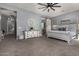 Bright primary bedroom showcasing a decorative console, sliding barn door entry to bathroom, and neutral-toned carpeting at 9183 W Foothill Dr, Peoria, AZ 85383
