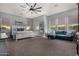 Spacious primary bedroom with large windows, plush carpeting, seating area, and ensuite bathroom at 9183 W Foothill Dr, Peoria, AZ 85383