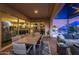 Inviting outdoor space with a dining area, lounge seating, and a view of the sparkling pool at twilight at 9183 W Foothill Dr, Peoria, AZ 85383