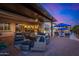 Relaxing outdoor living area with comfortable seating, a fire pit, and view of the pool and landscaped yard at 9183 W Foothill Dr, Peoria, AZ 85383